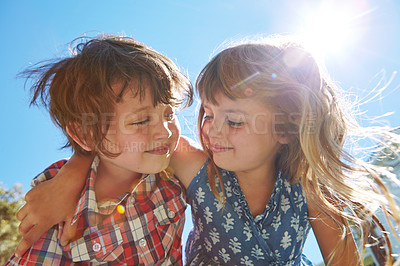 Buy stock photo Shot of an affectionate brother and sister embracing in their backyard