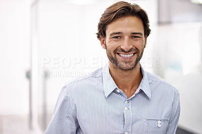 Buy stock photo Portrait of a handsome young businessman standing in his office