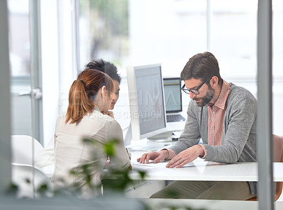 Buy stock photo A group of businesspeople going over some plans together