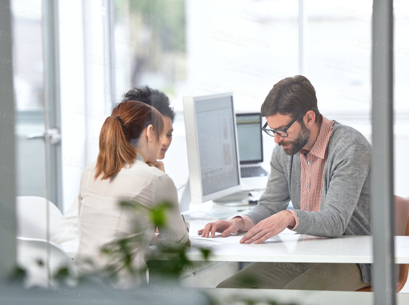 Buy stock photo A group of businesspeople going over some plans together