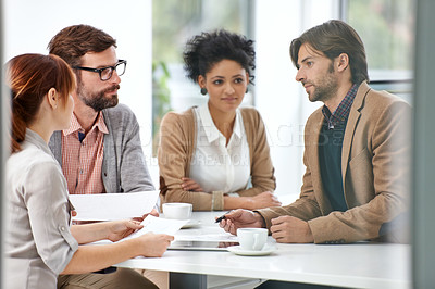 Buy stock photo A group of businesspeople going over some plans together