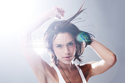 Buy stock photo Cropped portrait of an attractive young woman dancing with total freedom