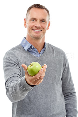 Buy stock photo Giving apple, studio portrait and man with fruit for health, diet and wellness isolated on a white background. Model person with nutrition vegan food in hand for healthy lifestyle and clean eating