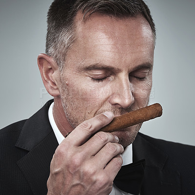 Buy stock photo Luxury, vintage and man smell cigars for smoking habit on gray background for wealth, power and success. Mafia boss, business gangster and face of senior male smelling tobacco for rich lifestyle