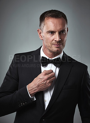 Buy stock photo Studio portrait of mature man, tuxedo and handsome, serious and isolated on grey background. Luxury, glamour and wealth, success with celebrity actor style, elegant and date for valentines day.