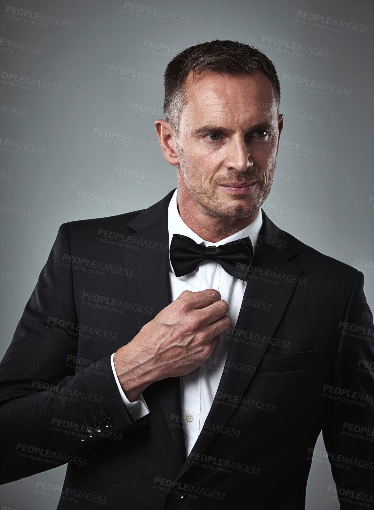 Buy stock photo Studio portrait of mature man, tuxedo and handsome, serious and isolated on grey background. Luxury, glamour and wealth, success with celebrity actor style, elegant and date for valentines day.