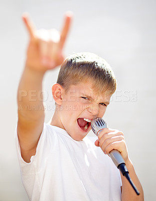 Buy stock photo Microphone, rock star and portrait of kid singing, creative talent or cool outdoor by wall. Child on mic, face and karaoke for music, song and recording voice, sound or performance at fantasy concert