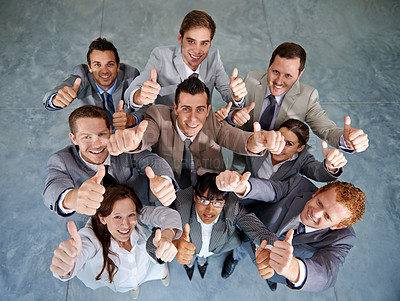 Buy stock photo Top view of a successful business team giving you an emphatic thumbs up