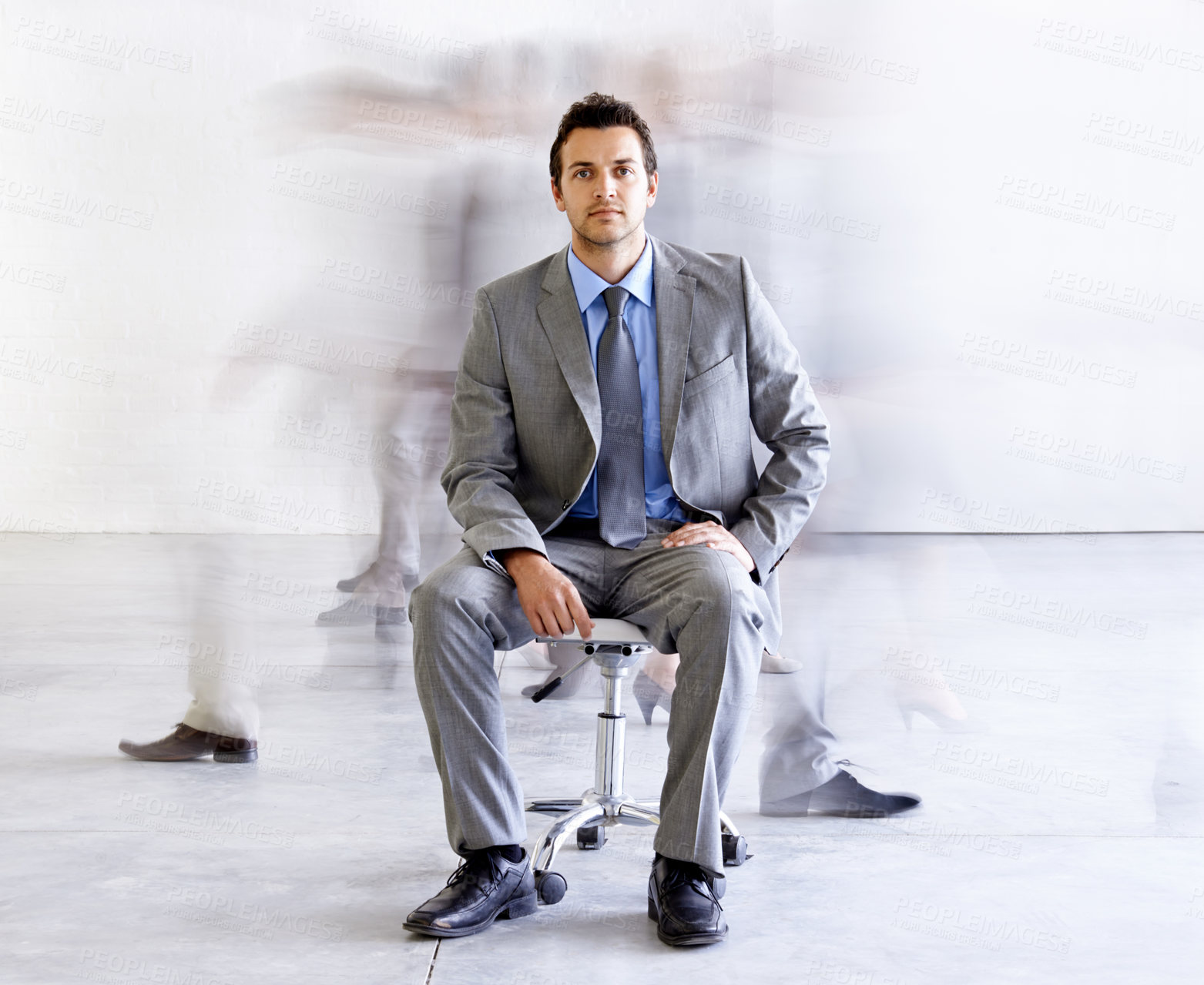 Buy stock photo Portrait, chair and a corporate man in a busy office with motion blur people walking for company productivity. Work, business and professional with a young employee in a suit sitting in the workplace