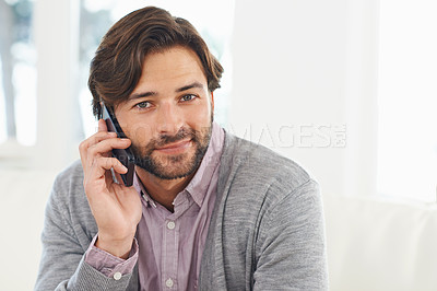 Buy stock photo A handsome young man using his cellphone