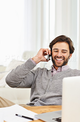 Buy stock photo A handsome businessman speaking on his mobile at his desk