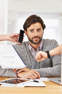 Buy stock photo A cropped shot of a handsome businessman with colleagues requesting various things from him