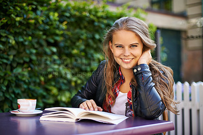 Buy stock photo Woman, smile and reading book at outdoor coffee shop, cafe or restaurant with espresso, latte or cup. Happy, girl and relax with green tea, drink or learning info in summer, morning or city bistro
