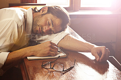 Buy stock photo Pub, sleeping and man with a notebook, alcoholic and tired with deadline, depression and handover. Person, guy and drinker with a book, pen and glasses with fatigue, exhausted and bar with habit