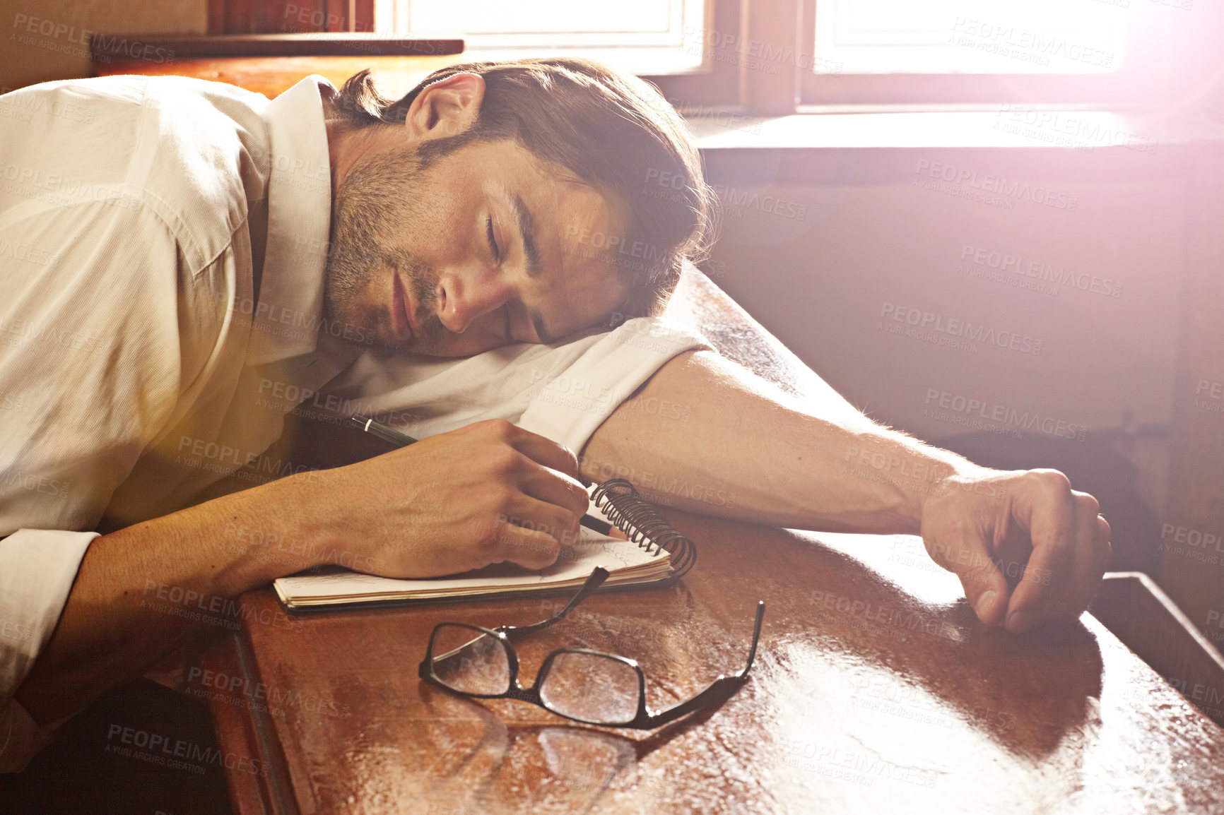 Buy stock photo Pub, sleeping and man with a notebook, alcoholic and tired with deadline, depression and handover. Person, guy and drinker with a book, pen and glasses with fatigue, exhausted and bar with habit