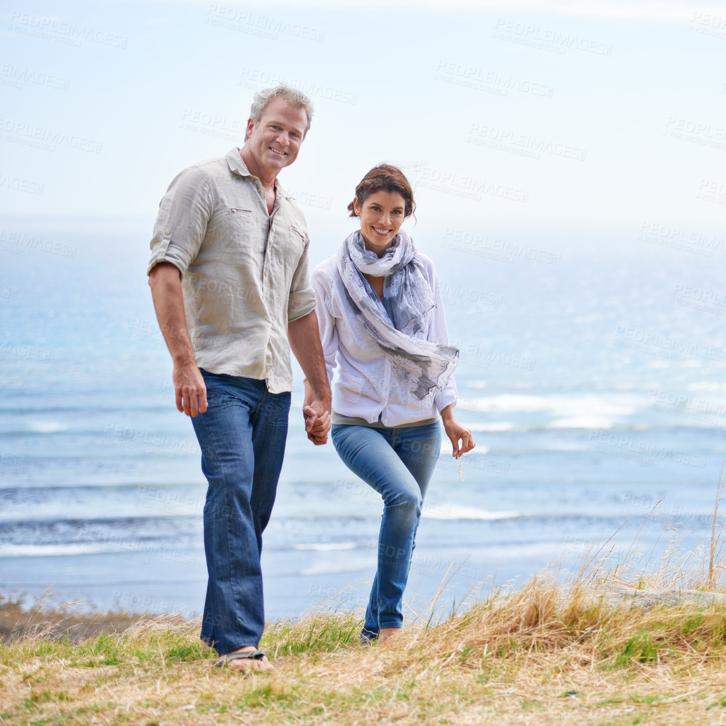 Buy stock photo Happy, mature couple and portrait of holding hands at the sea, ocean or walk on the beach in retirement. Summer, vacation or holiday with old man and woman together with love and support in marriage