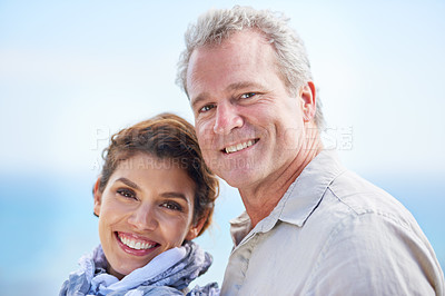 Buy stock photo Couple, smile and portrait in outdoors, travel and bonding or love, affection and security in relationship. Mature people, happy and face on vacation, holiday and adventure or getaway, sky and care