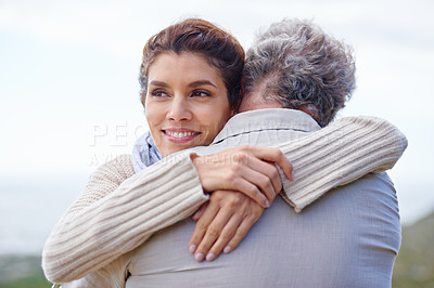 Buy stock photo Rearview shot of a mature man being hugged by his wife