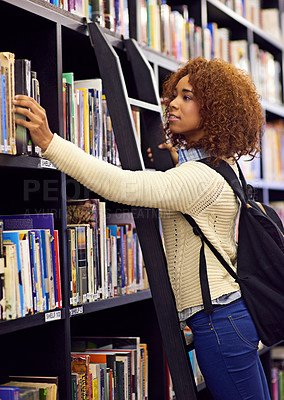 Buy stock photo Black woman search for book in library, student at college and study for exam or research for project on campus. Education, learning and academic development with female person on ladder by bookshelf