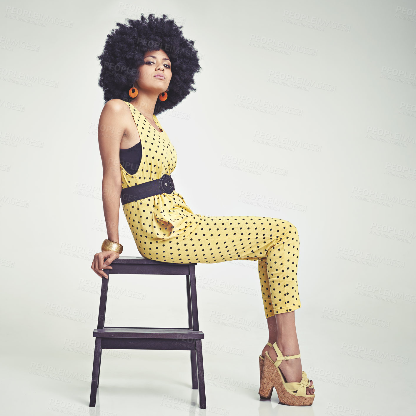 Buy stock photo Black woman, portrait and retro fashion in vintage yellow jumpsuit and high heels on a gray studio background. African female person with afro, makeup or jewelry in style for elegance on mockup space