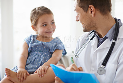 Buy stock photo Happy, child and pediatrician writing in clinic for healthcare consulting, wellness consultation and checkup. Medical doctor, girl kid and notes of assessment report, analysis and results in hospital