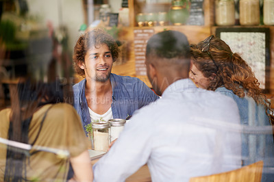Buy stock photo A group of friends meeting up for coffee in a cafe