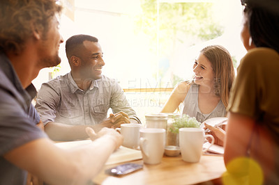 Buy stock photo Shot of a group of friends talking in a cafe
