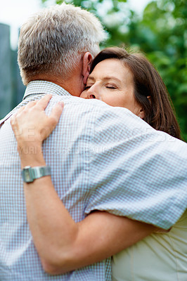 Buy stock photo Senior couple, garden and a hug for commitment, care and bonding together in retirement. Comfort, elderly and a man and woman with affection, romance or loyalty in a marriage in a park for a date