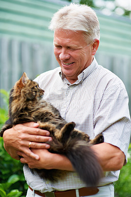 Buy stock photo Elderly, man and love for cat is outdoors with care for pets, animals and furry childhood friend. Happy, male person and  bonding with companion in backyard of house with kitten, embrace and garden