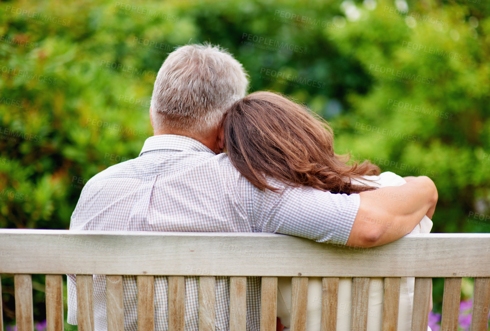 Buy stock photo Park, back view or mature couple on bench for support, trust or hope in commitment together in nature. Hug, garden or senior man bonding to relax with woman on anniversary for love, wellness or care