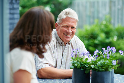 Buy stock photo Cropped shot of a senior couple sitting outside