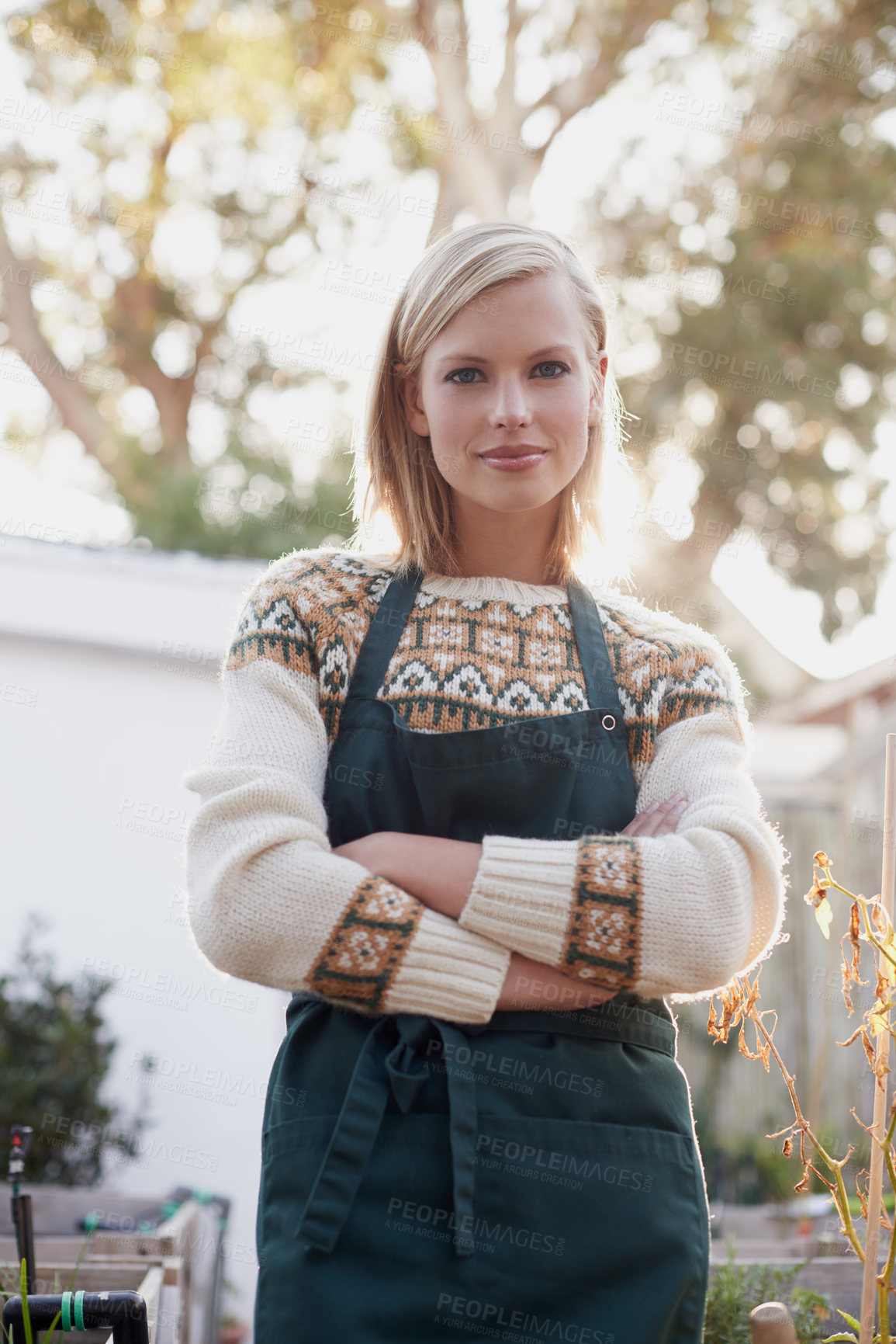 Buy stock photo A beautiful young woman busy gardening