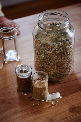 Buy stock photo Jar, tea leaves and herbal plant on kitchen counter or health benefits or morning beverage, refreshing or wellness. Bottle, vitality and prepare as hot drinking or jasmine, hibiscus or stress relief