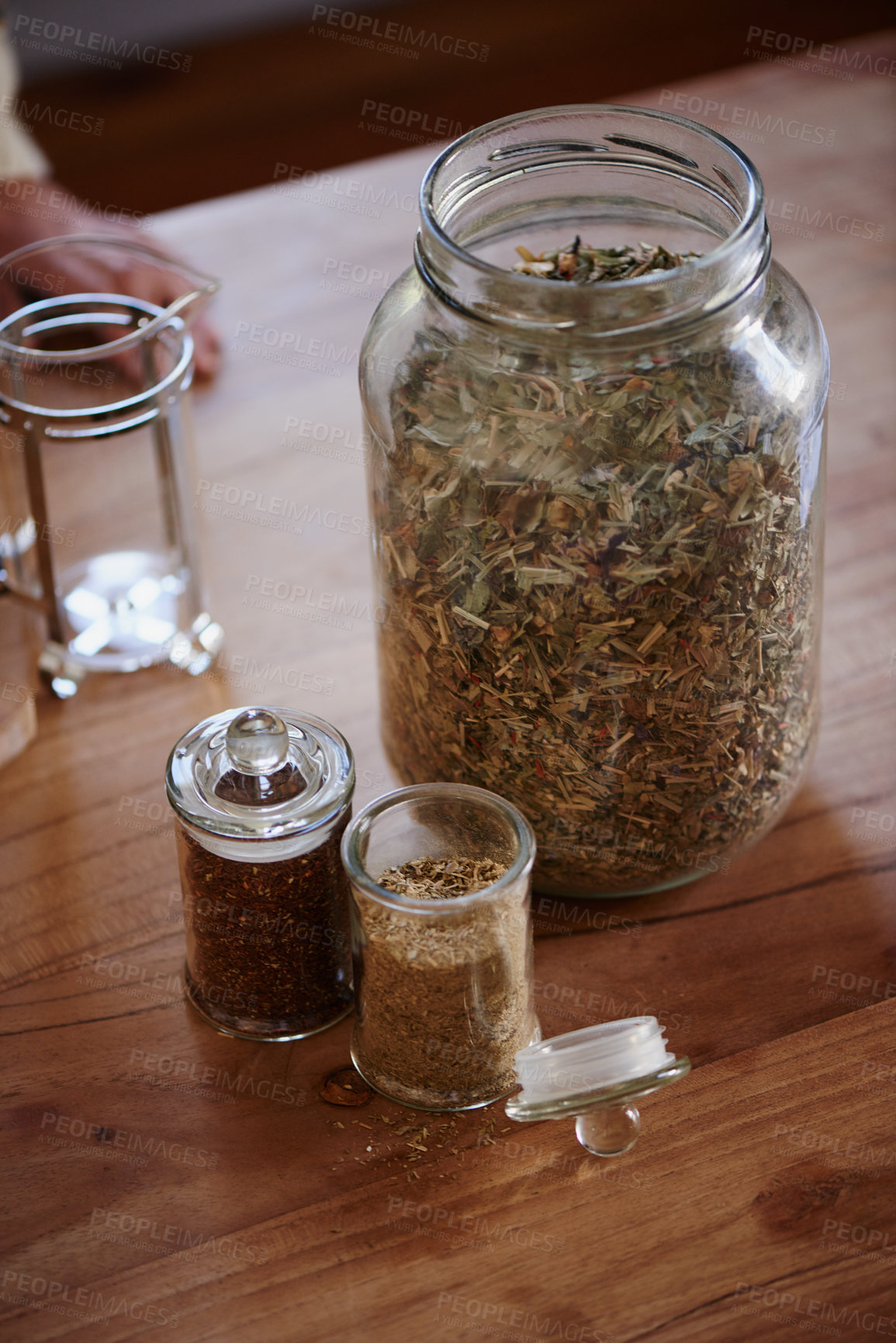 Buy stock photo Jar, tea leaves and herbal plant on kitchen counter or health benefits or morning beverage, refreshing or wellness. Bottle, vitality and prepare as hot drinking or jasmine, hibiscus or stress relief