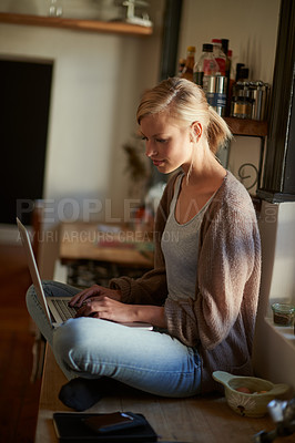 Buy stock photo Woman, kitchen and laptop with technology, counter and connection for learning, internet or email. Influencer, and research for blog, payment or registration for planning, working or remote work