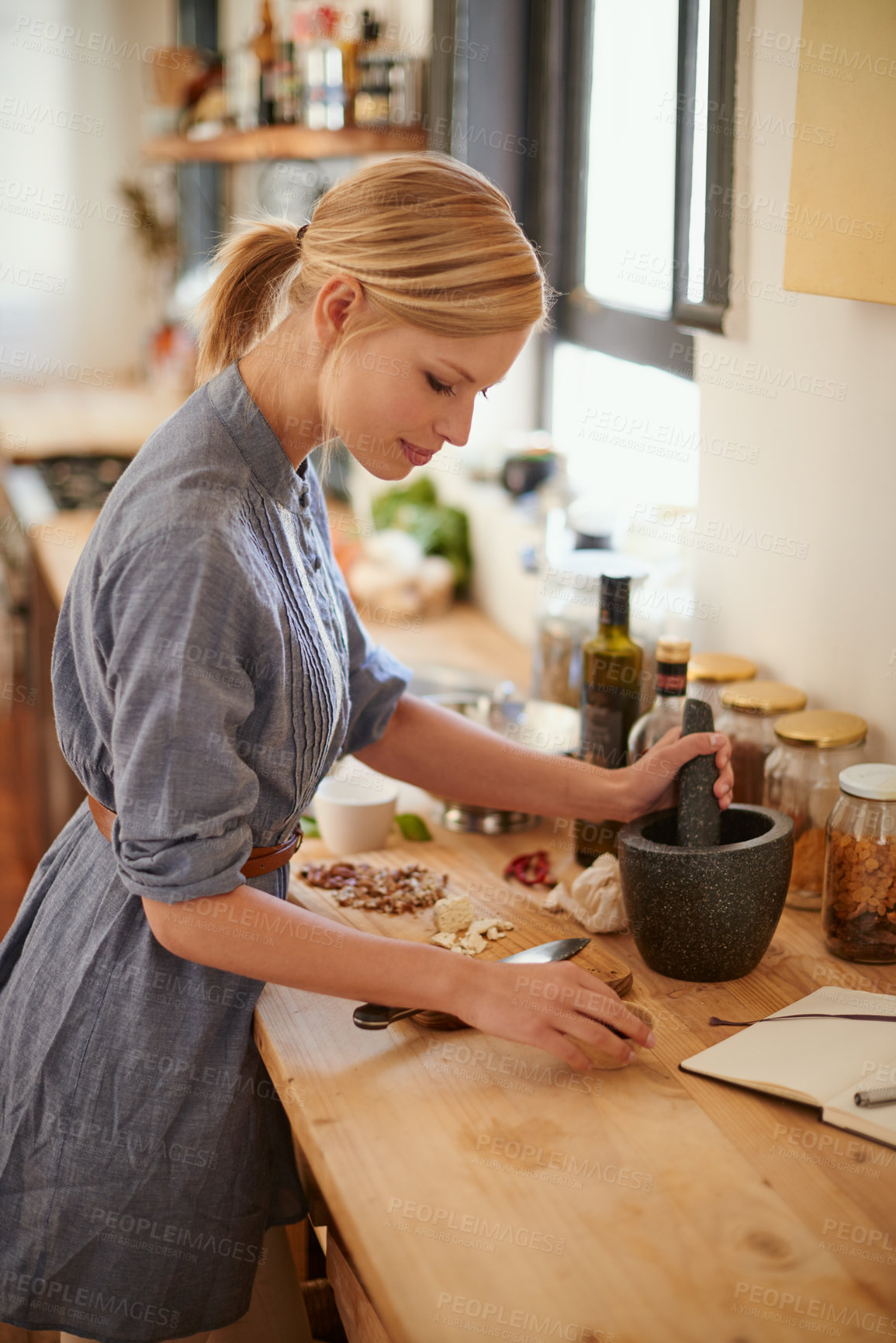 Buy stock photo Cooking, woman and mortar with grind in a home with diet, nutrition and healthy food with pestle. Kitchen, bowl and happy from organic and vegan lunch with mushroom and wood board with wellness