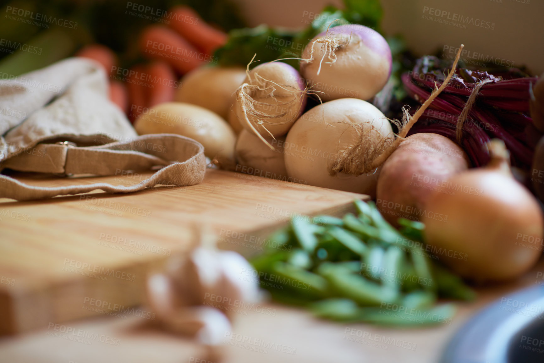 Buy stock photo Shot of a variety of vegetables surrounding a cutting board