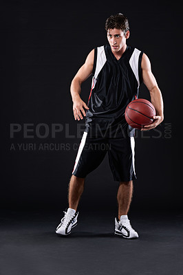 Buy stock photo Full length shot of a male basketball player in action against a black background