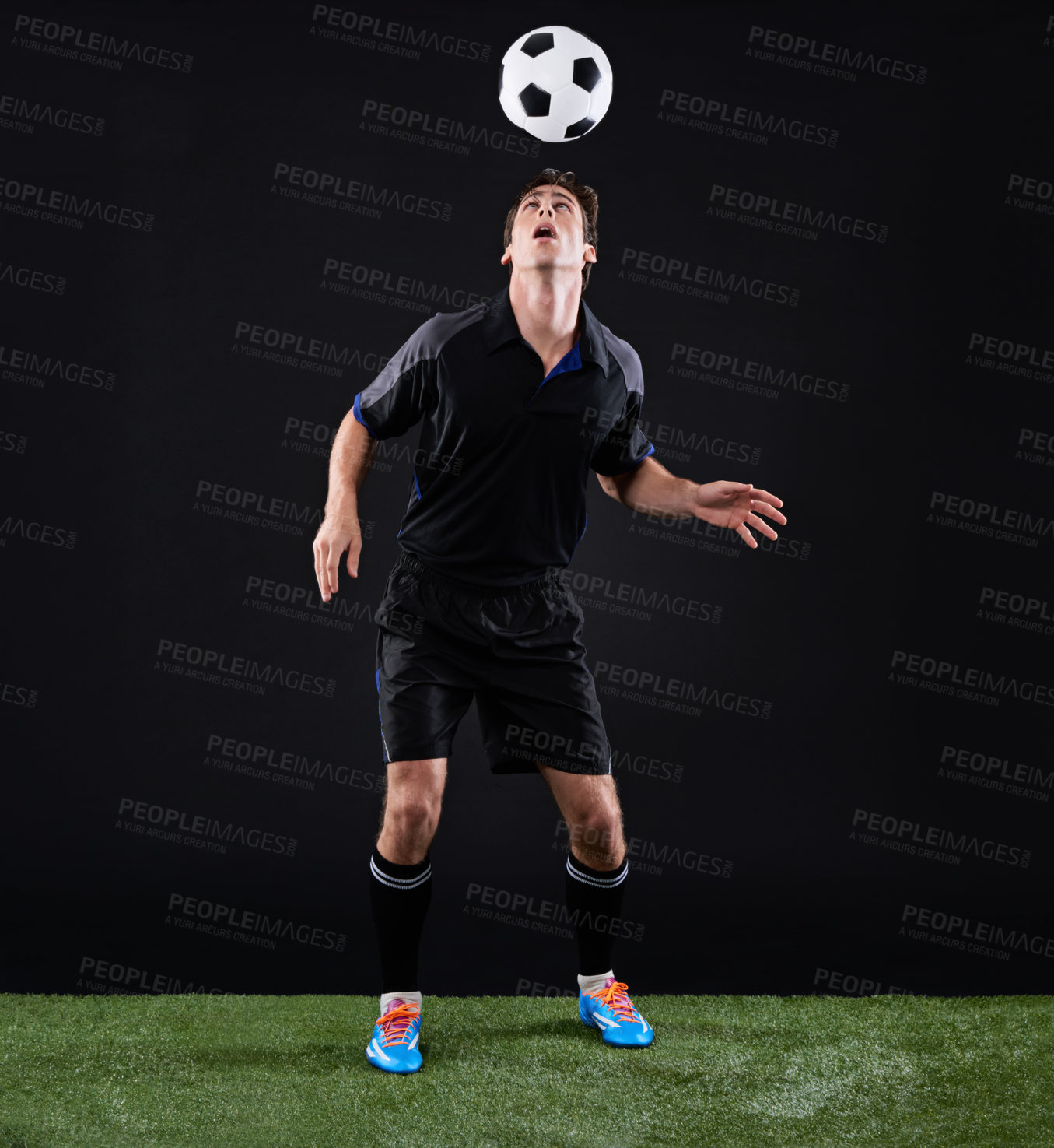 Buy stock photo Football, man and athlete with ball on head by grass on black background for training, exercise or fitness. Sport, field and male soccer player with equipment for skill, practice or workout in studio