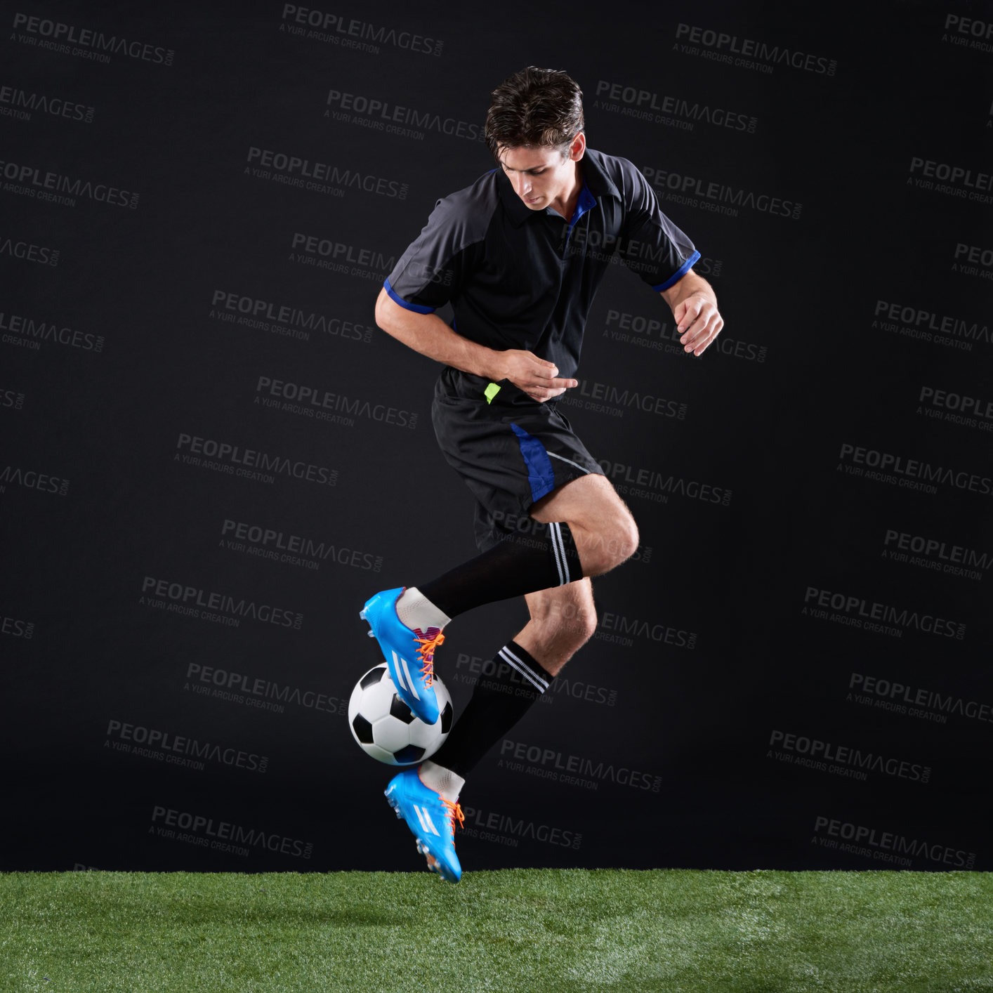 Buy stock photo Full length studio shot of a handsome young soccer player isolated on black