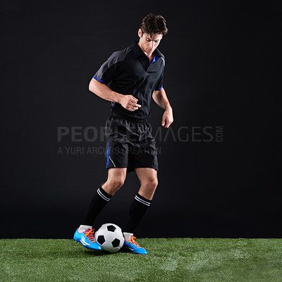 Buy stock photo Fitness, ball and man soccer player on grass by black background for training, exercise or game. Sports, field and male athlete with equipment for football practice, workout or match in studio.