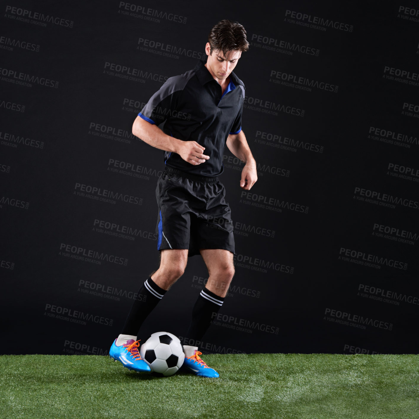 Buy stock photo Fitness, ball and man soccer player on grass by black background for training, exercise or game. Sports, field and male athlete with equipment for football practice, workout or match in studio.