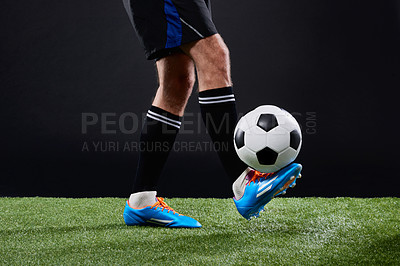 Buy stock photo Cropped shot of a soccer player playing soccer