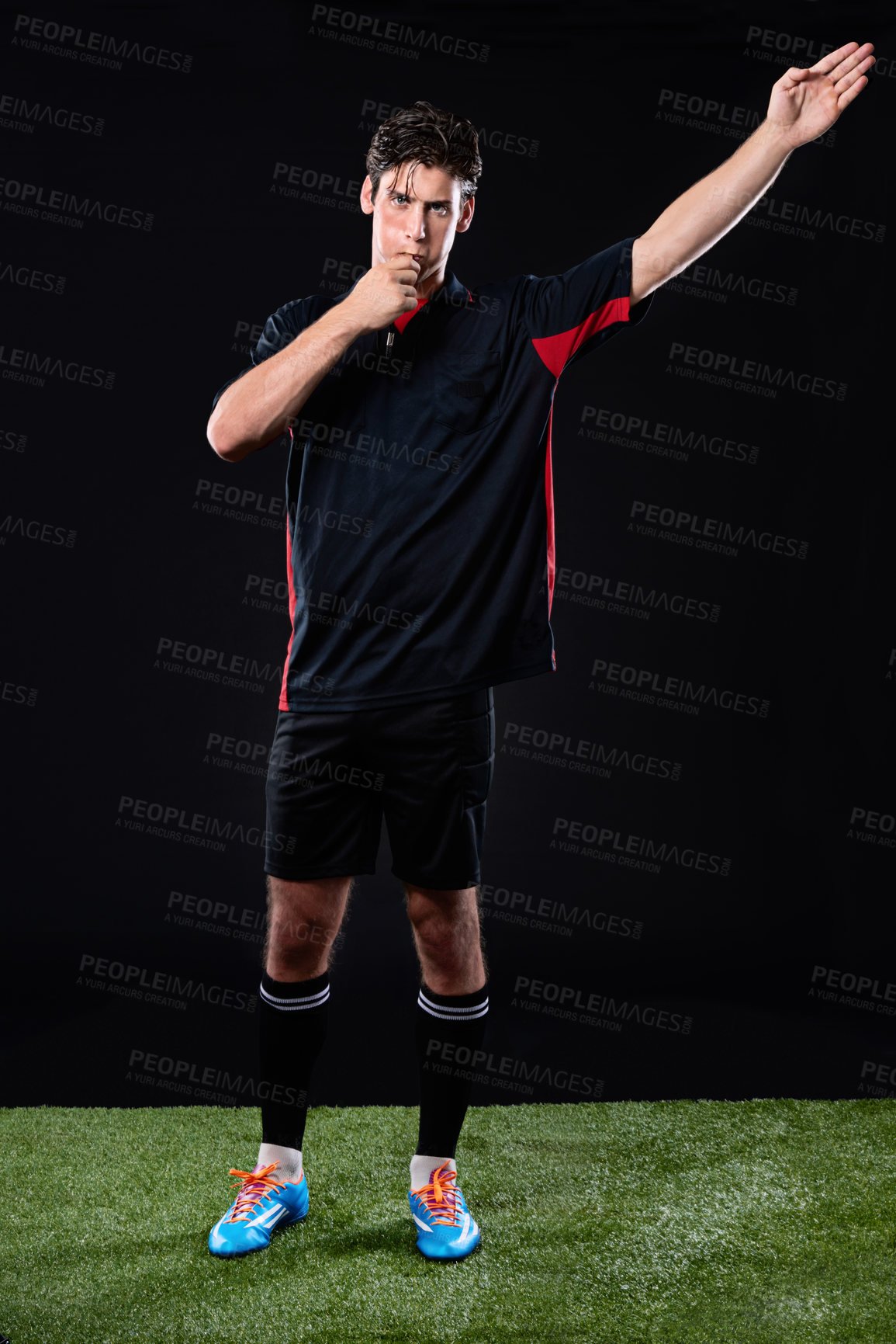 Buy stock photo Referee, pointing and blowing whistle in studio for decision in sport, rules for off side or penalty. Male person, black background and hand for stop in game, call or sign with error at night