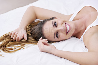 Buy stock photo Woman, portrait and cozy in bed on weekend, lazy and peaceful at home in morning. Happy female person, smiling and satisfaction while resting in bedroom, wake up and good mood on vacation or holiday