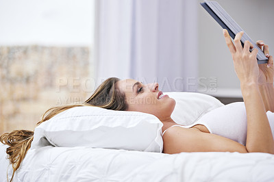 Buy stock photo Woman, relax in bed and tablet for online streaming, movie and watch on website with internet subscription. Young person in her bedroom on digital technology for reading news or social media at home