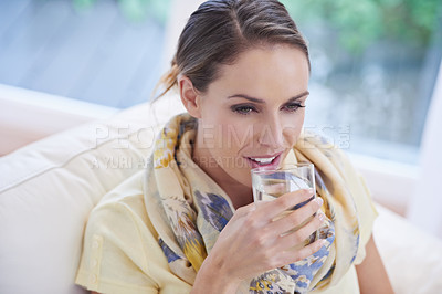 Buy stock photo Woman, smile and drinking water from glass in home, thinking and memory with choice for detox on sofa. Person, vision and liquid with ideas, relax and happy on couch in lounge, house or apartment