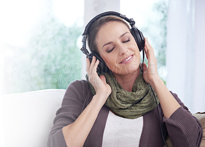 Buy stock photo Home, smile and woman with headphones, listening to radio and peaceful with weekend break and joyful. Apartment, podcast and person on a couch and headset for audio, sound and streaming music