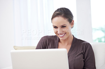 Buy stock photo Woman, smile and laptop on sofa for remote work, update blog post or reading news on social media at home. Happy freelancer, computer and download with internet and movie subscription in living room