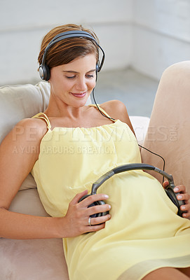Buy stock photo Woman, song or headphones on pregnant stomach in house living room for sound, audio or childcare listening development. Relax, pregnancy or happy person and music, podcast or wellness growth support